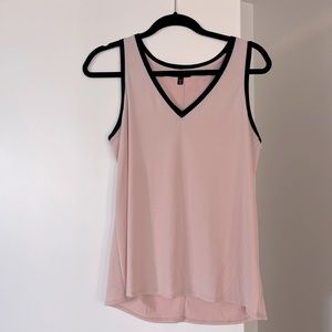 Baby pink tank with black detailing. Lightweight material with some stretch.
